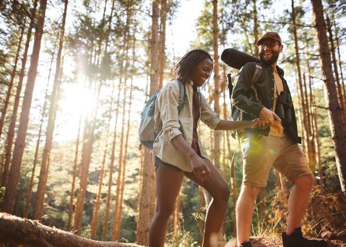 two people hiking through woods