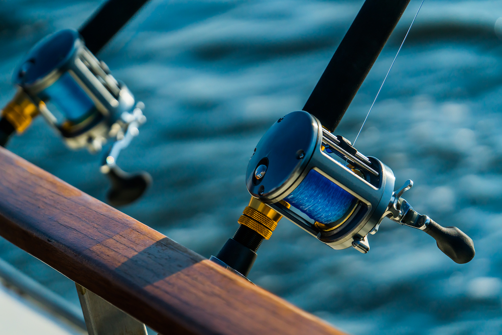 Fishing gear on deep sea sport fishing trip in the bay at sunset