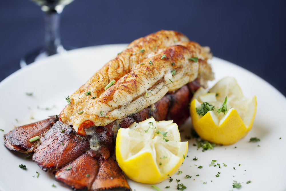 Large lobster tail served with white wine. 