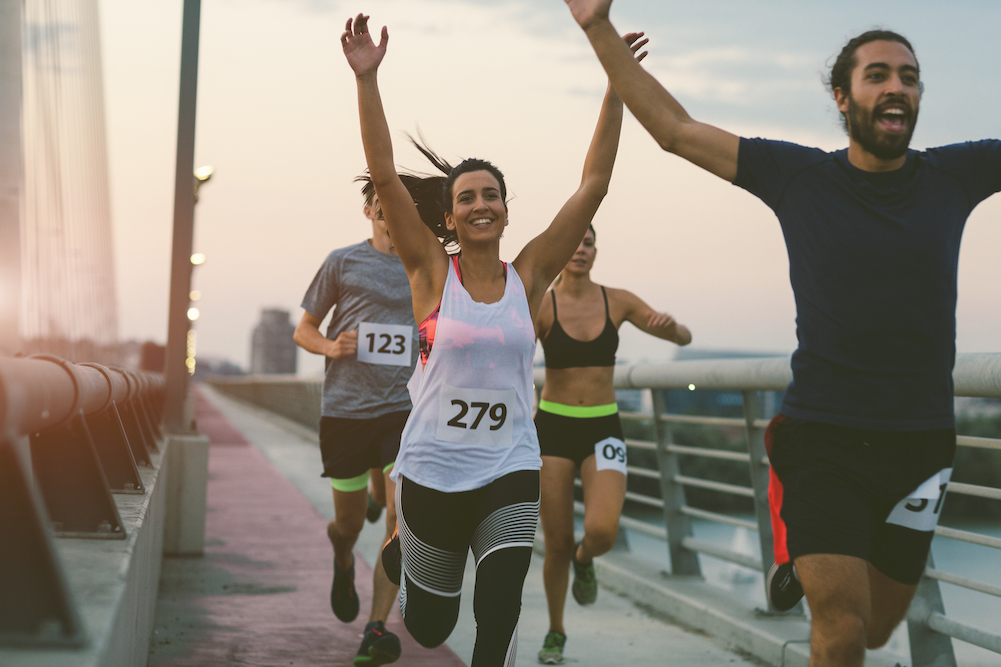 runners with arms raised 