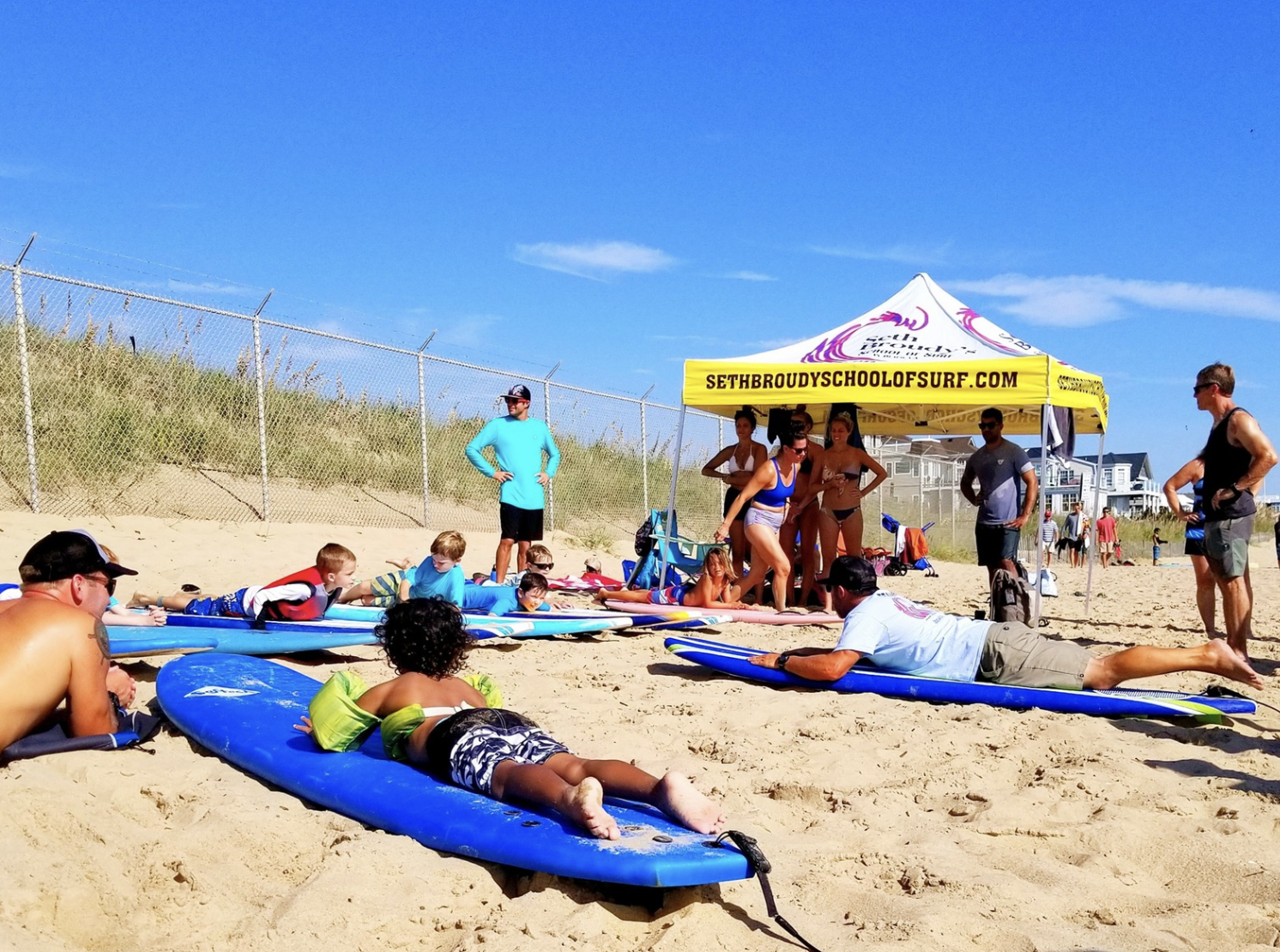 families laying in the sand enjoying the beach