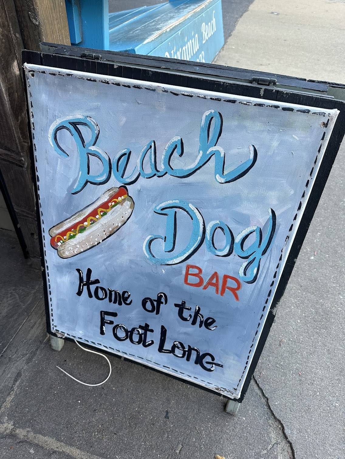 Beach dogs sign in front of their business 